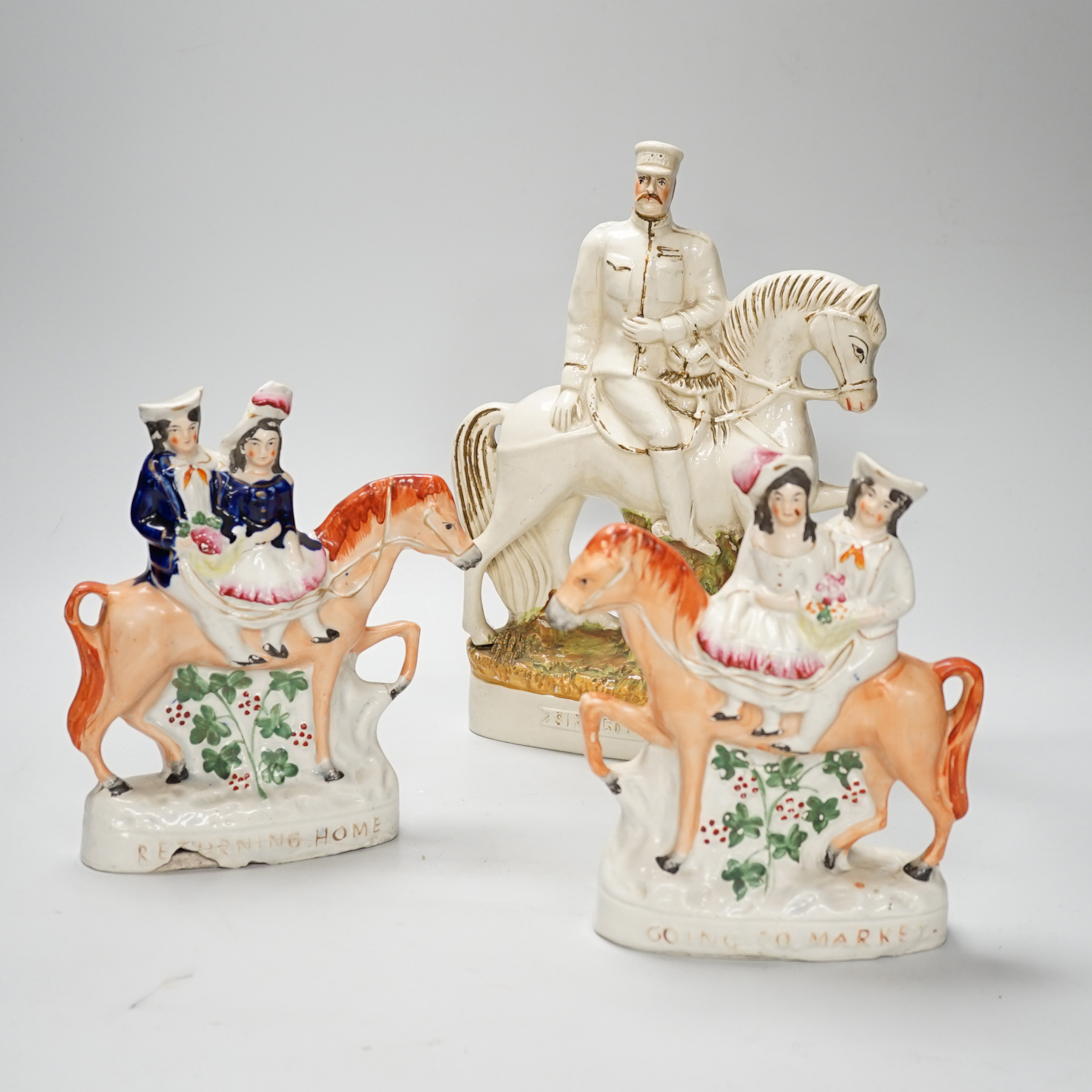 A pair of Staffordshire 'market' groups and a General Sir Redvers Buller equestrian group (3), 30cm